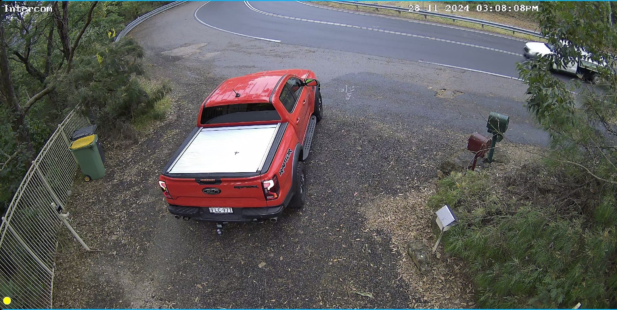 Daytime CCTV view of the remote gate, driveway and road at a Blue Mountains property