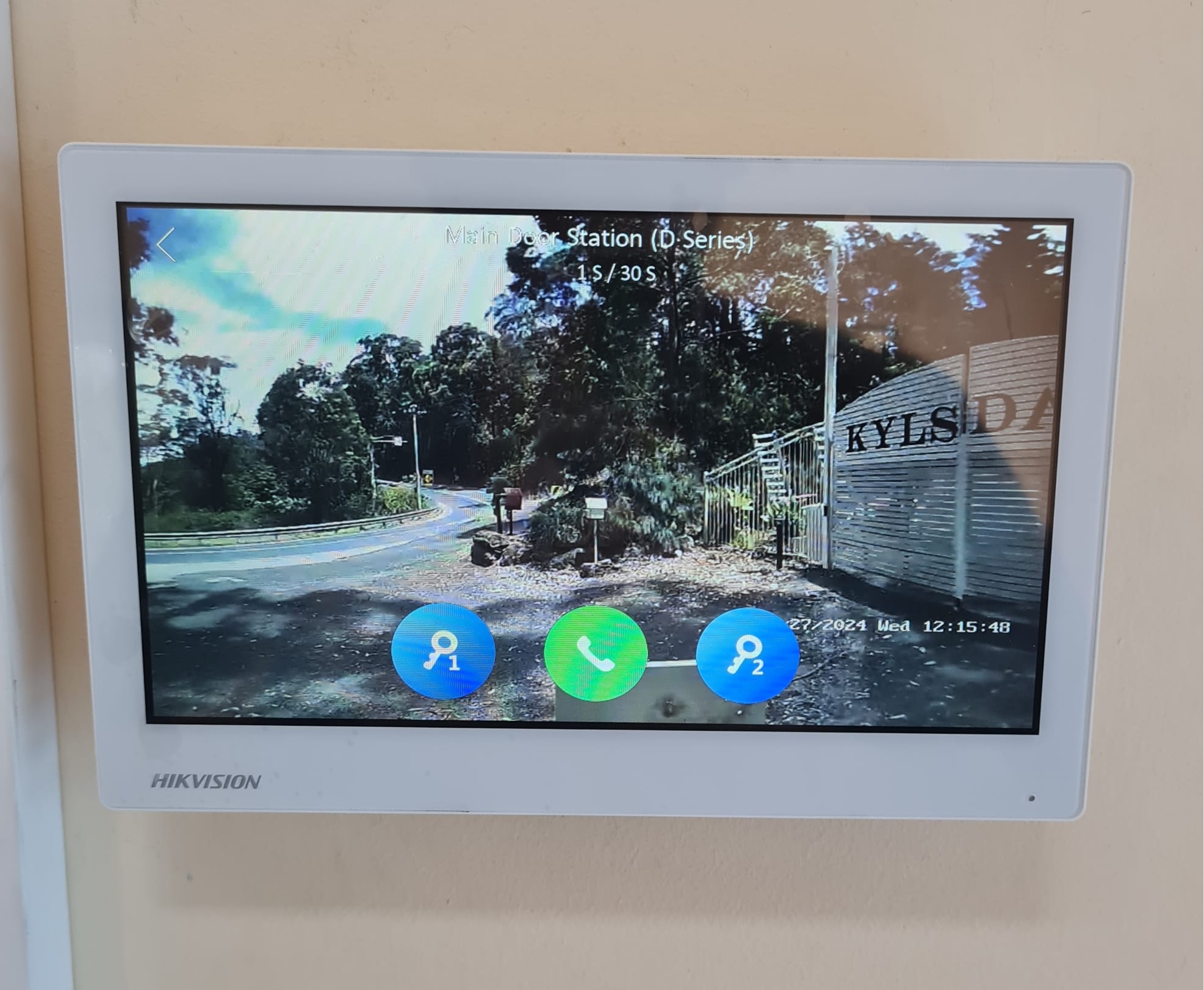 Hikvision indoor monitor displaying a live view of the remote main gate