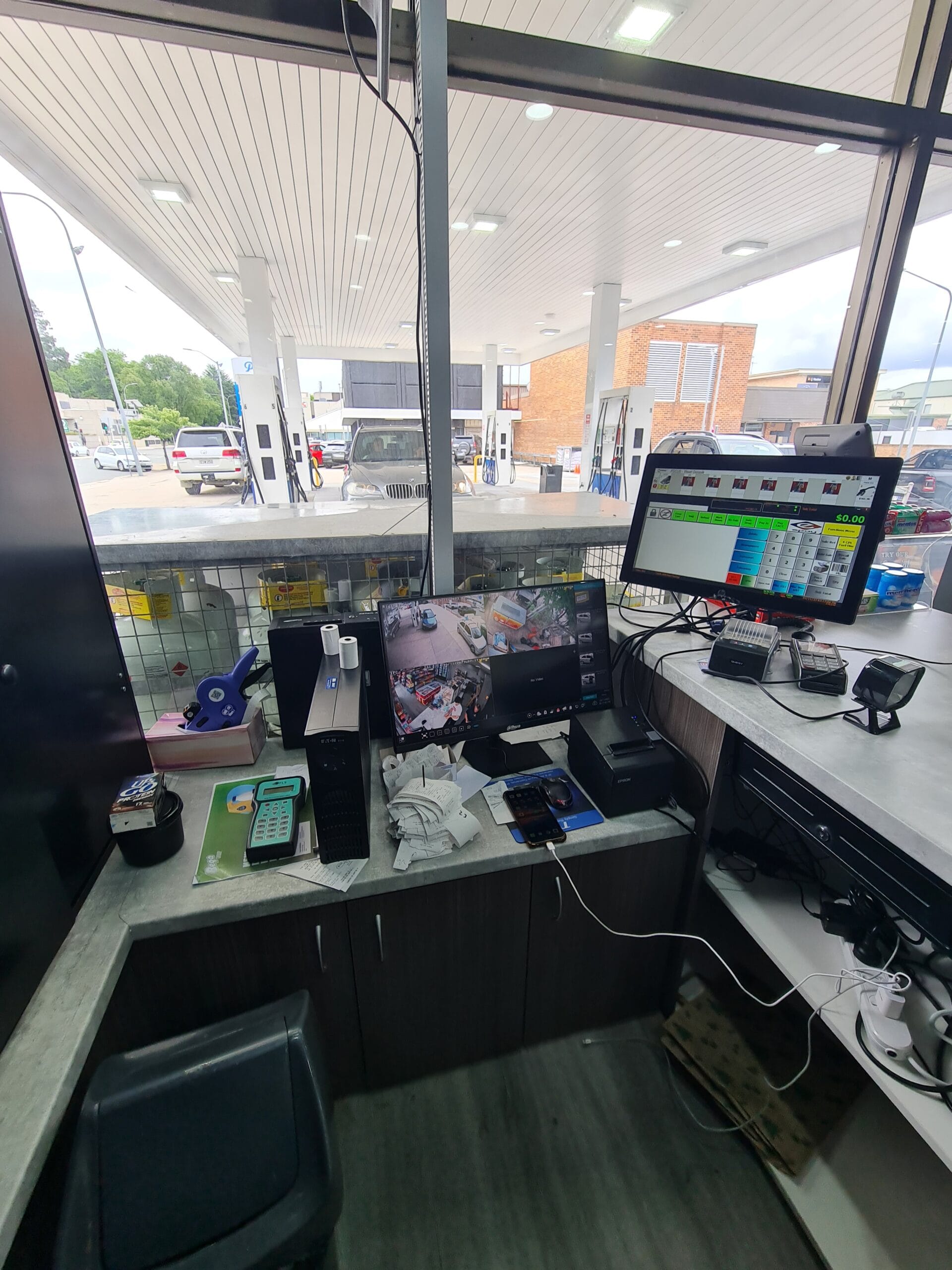 Petrol station CCTV coverage showing forecourt, fuel pumps, retail store, counter and customer areas