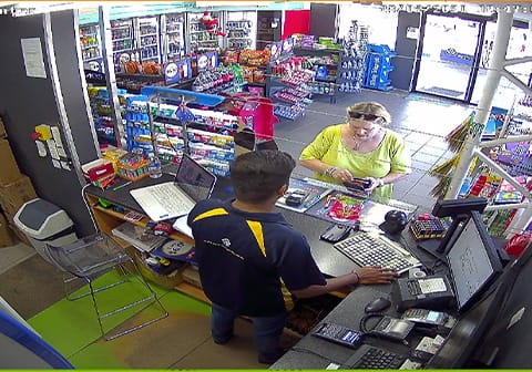 Petrol station counter CCTV monitoring customer transactions and staff security